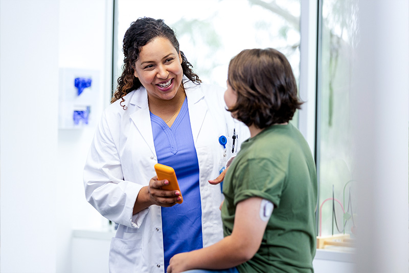 Patient discussing chronic conditions with their provider in a doctor's office.