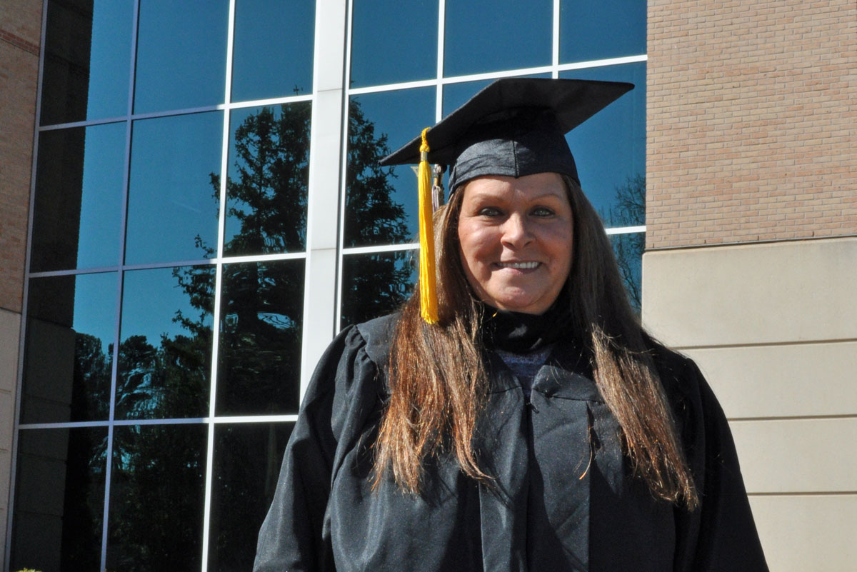 Vicky Hadaway celebrating her cardiac rehabilitation graduation in front of St. Mary's Hospital